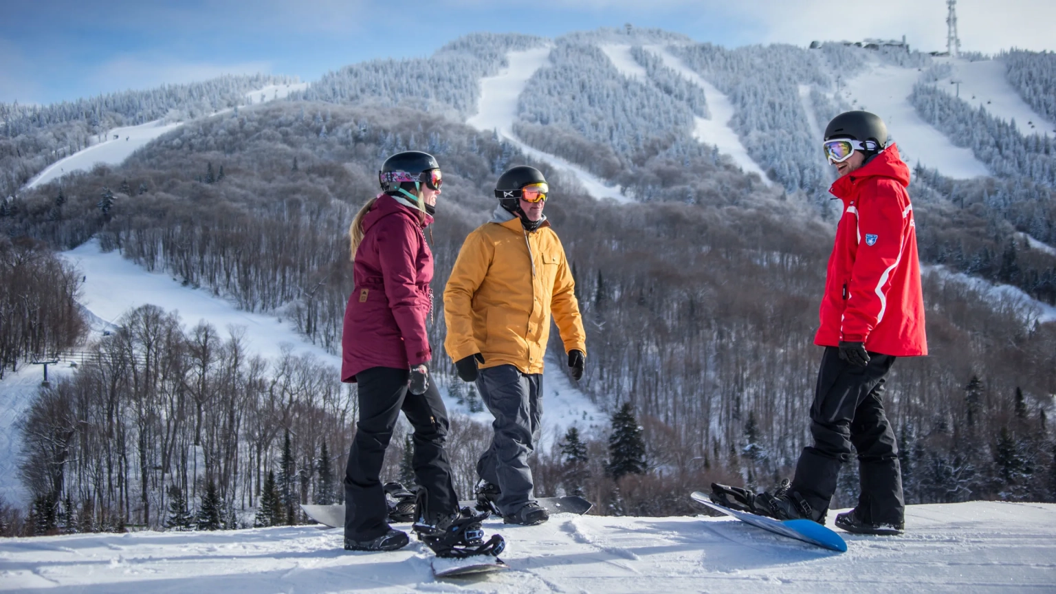 On-site ski school packages at Les Suites Tremblant, highlighting an adult snowboarder practicing technical turns during private lessons on a groomed winter slope in the Laurentian Mountains, Quebec.